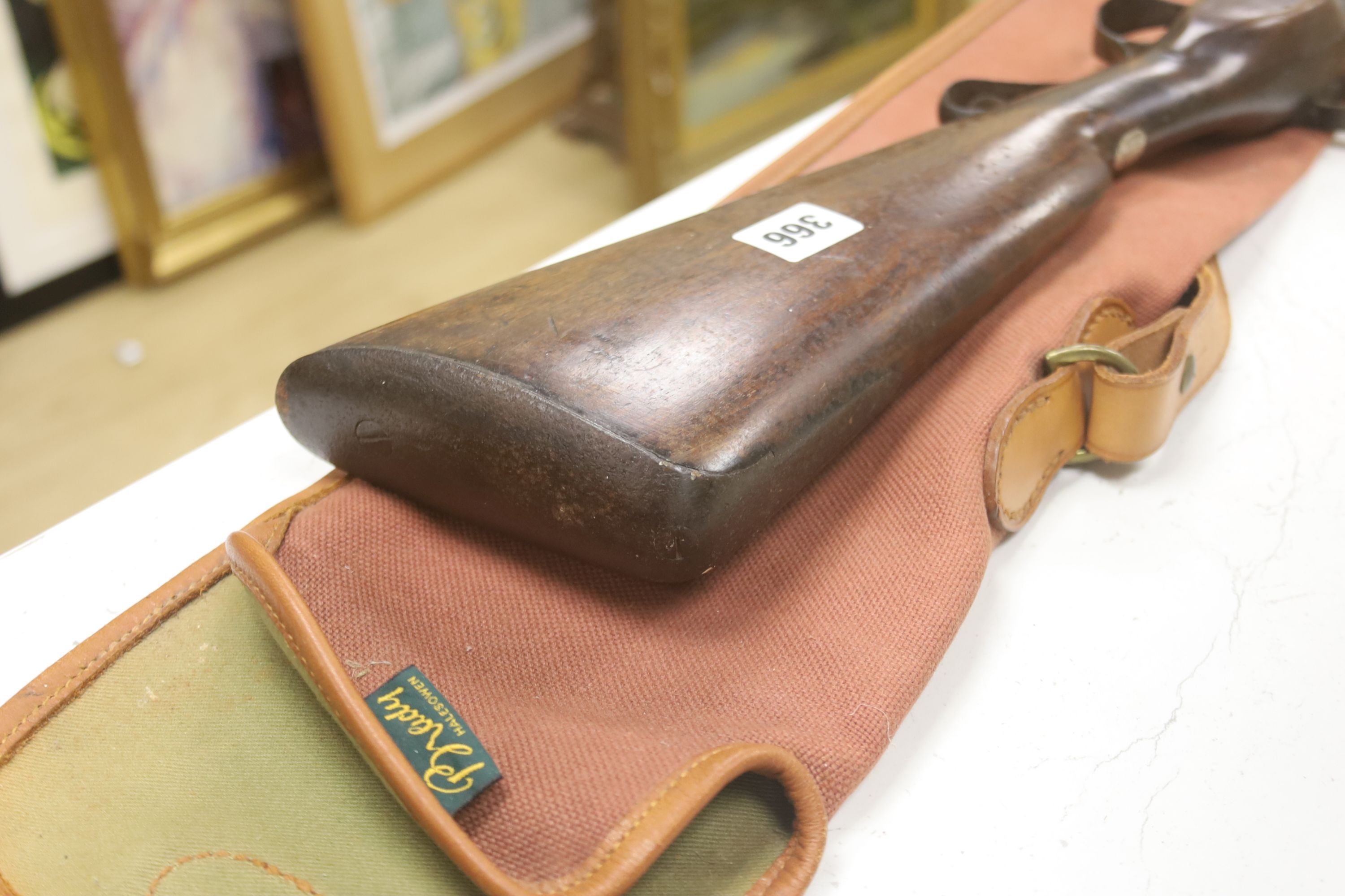A 19th century percussion rifle, walnut stock, with ram rod, in canvas case, complete with gun cleaning kit
